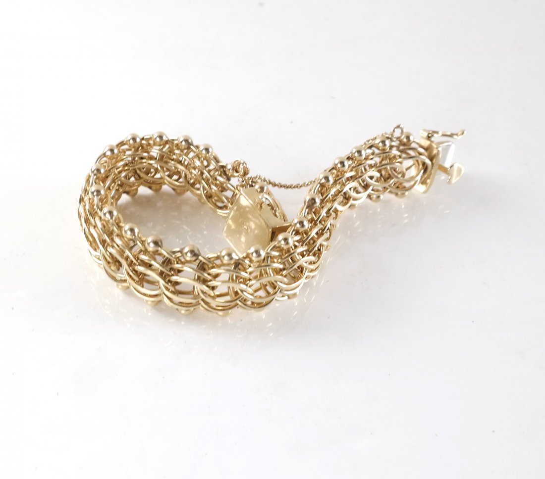 14k Yellow Gold Ladies' Bracelet: 14k gold bracelet featuring strands of gold hoops gathered with gold balls. [8" L x 3/4" W approximately]. 48.8 dwt.