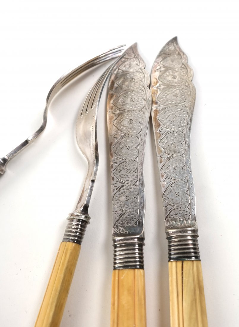 Cased Silver Plate Fish Service: Set of 12 forks and 12 knives with carved bone handles and bright cut blades. Most handles cracked. Wear and losses to mahogany case.