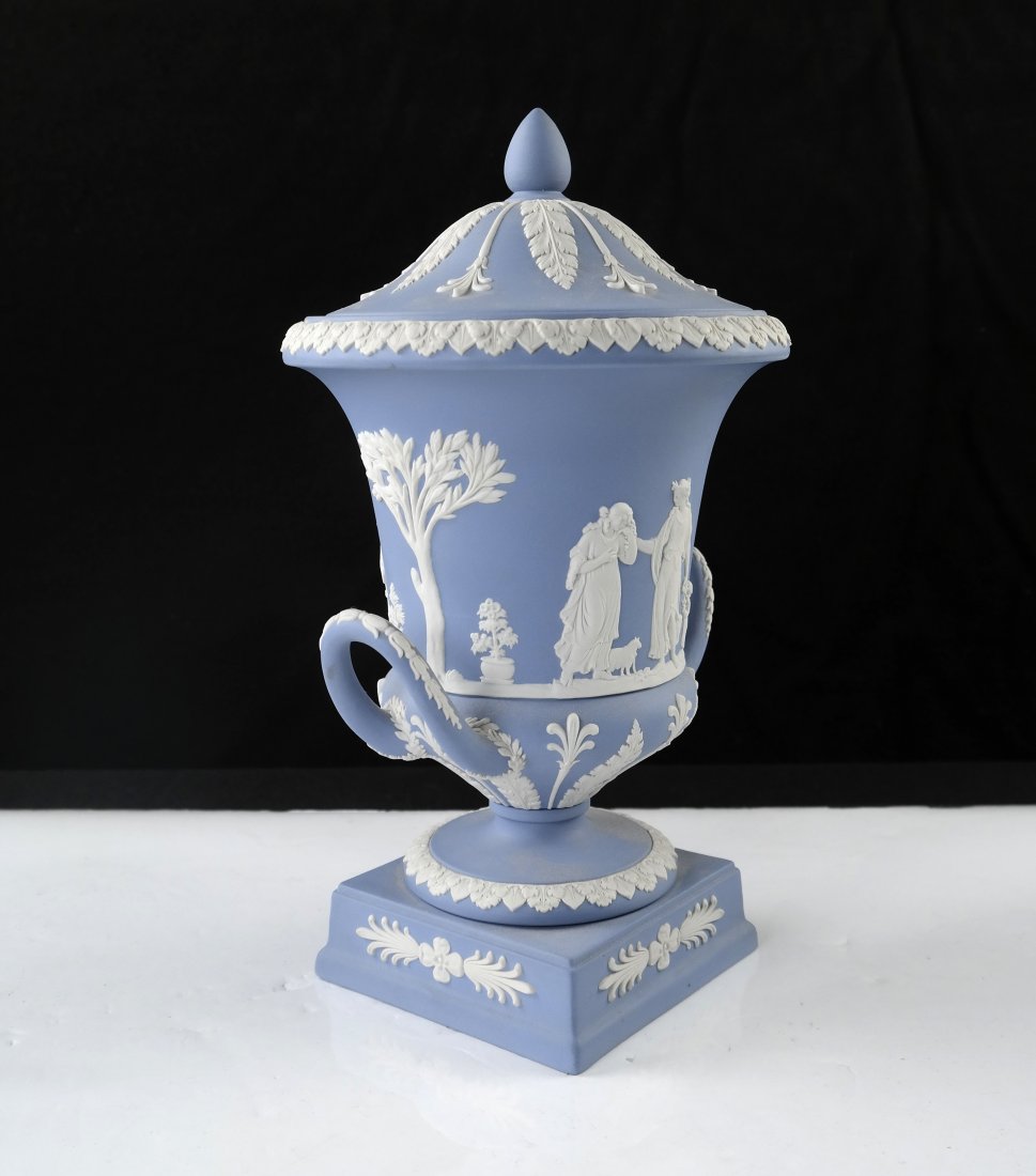 Wedgwood Blue Jasperware Urn: Campagna form covered urn sprig-decorated with classical decoration. Marked: Wedgwood / Made in England. [12" H]. Good condition.