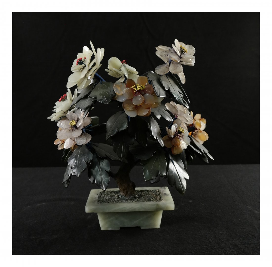 Chinese Hardstone Plant: Flowering shrub carved from carnelian and other hardstone, mounted in a jade planter. [10" W x 6" D x 11 1/4" H]. In good condition.