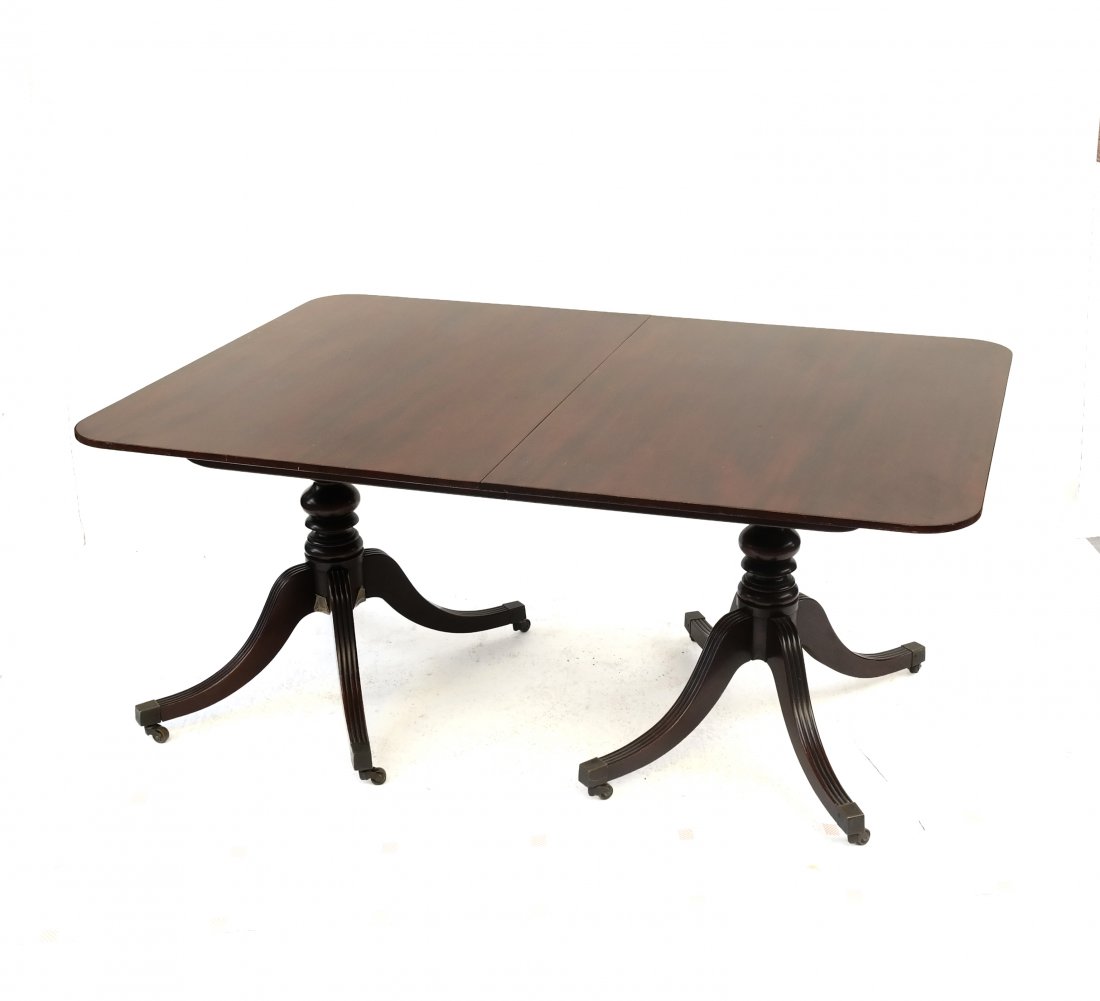 English-Style Dining Table: Double pedestal mahogany table with two leaves. [66" L x 44" D x 29 1/2" H; Leaves:15" each].