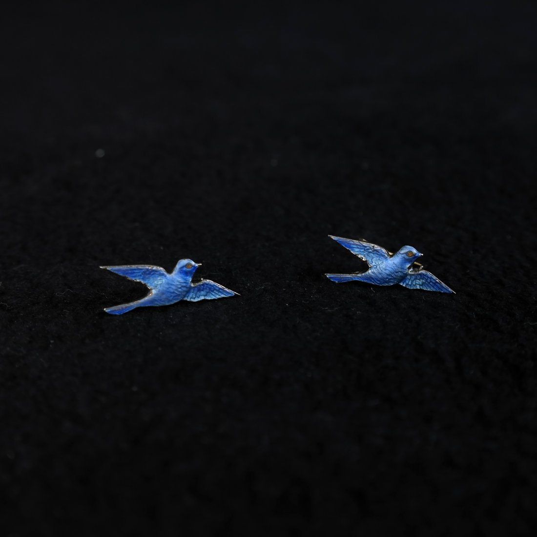 Pair of Silver Enameled Bluebird Pins: Sterling sweater pins depicting bluebirds in flight. [7/8" W x 3/8" H]. Enamel in good condition.