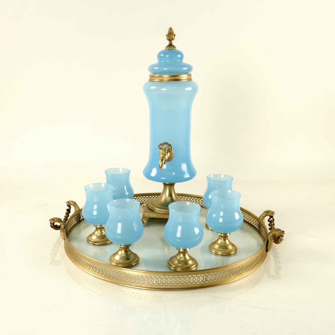 7-pc Blue Opaline Cordial Set with Tray: Blue opaline glass and gilt bronze urn and 6 glasses, along with an unrelated tray. [Urn: 13 1/2" H; Tray: 13" Dia]. In good condition.
