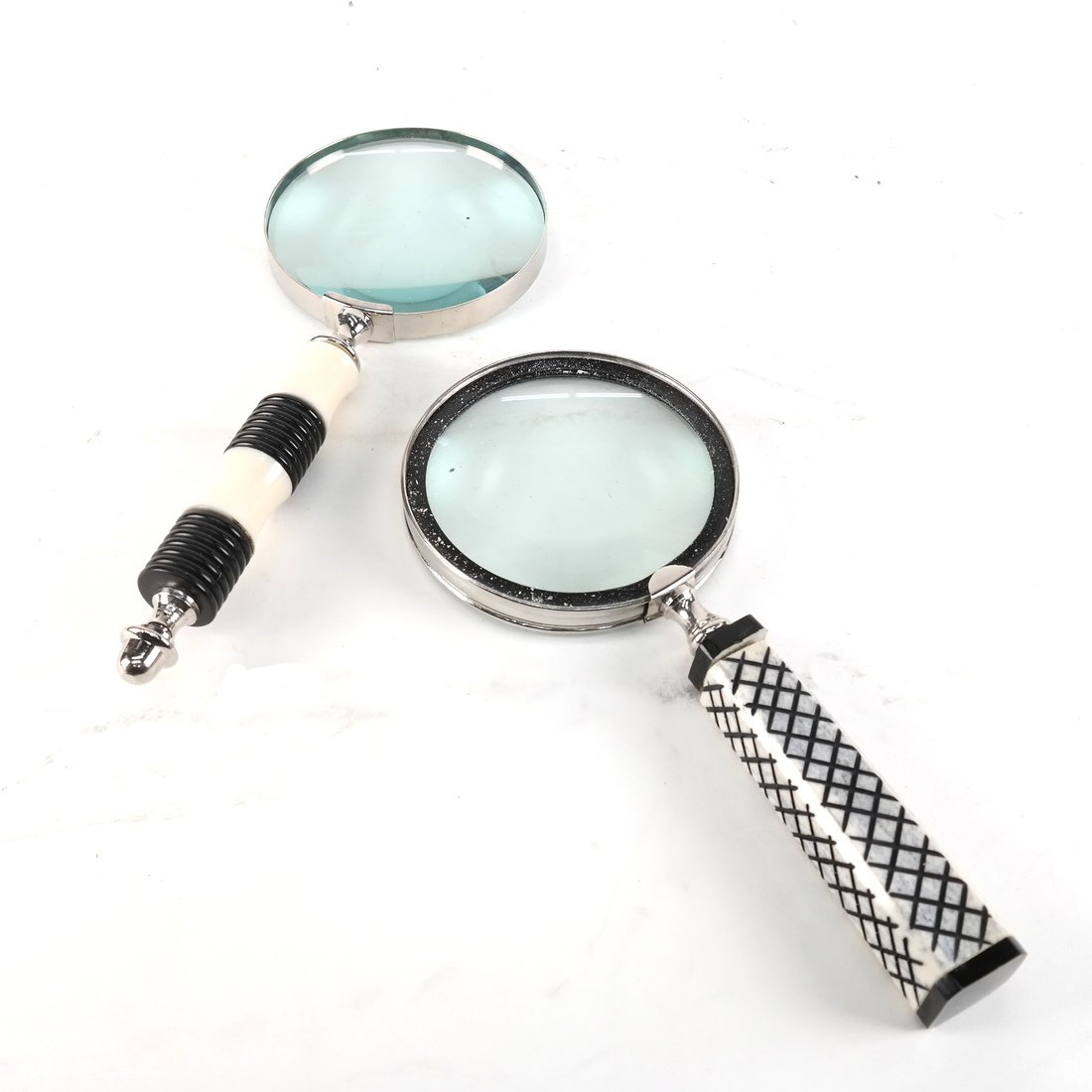 Two Magnifying Glasses: Two magnifying glasses, one with a broken handle. [10" L]. Sold "as is".