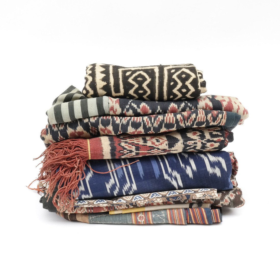 Assortment of Linens and Textiles: Ten items; variety of Indonesian textiles and linens. Sizes vary [11" H x 12" W to 34" H x 50" W]. In fair condition, sold as is.