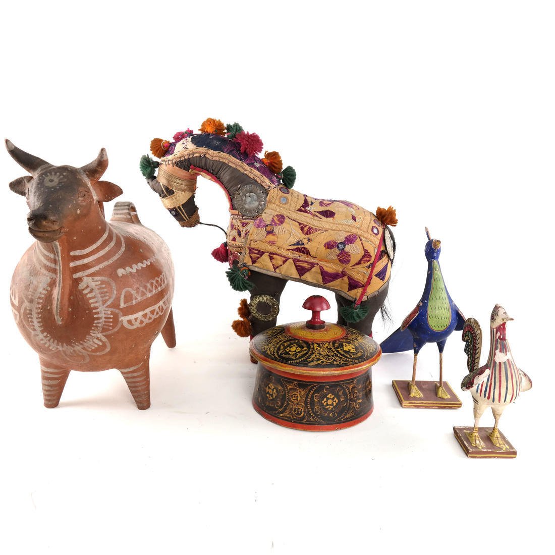 Mixed Lot of Decorative Objects: Comprising of embroidered stuffed horse from India [14 1/2" H x 15" L]. Worn. Metal jug in the shape of a cow [13" H x 13" W]. Worn. Round box with lid [6 1/3" D]. Worn. 2 painted wooden bids, chips t