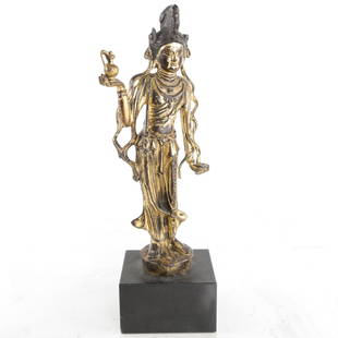 Gilt Bronze Standing Buddha Statue: Serene gilt bronze figure of a standing Buddhist deity with draped robes and ornate jewelry, holding a water cup. Mounted to an old heavy polished marble plinth base. [4" W x 2 1/2" D x 9" H].