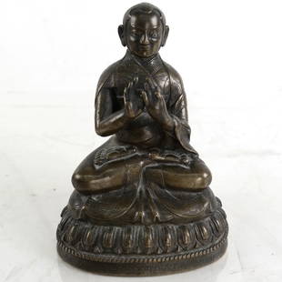 Early Asian Bronze Figure: An early seated Asian figure with incised decor along the base(border) and incising underneath . [4 3/4" H x 3 1/2" x 2 1/2"]. Overall good condition.