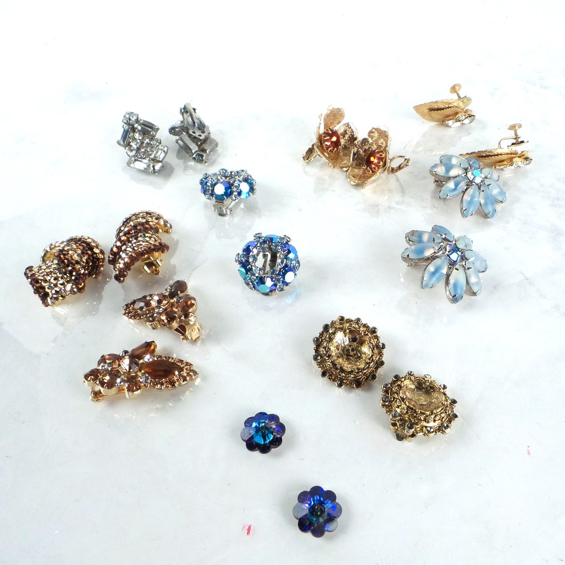 9 Pairs Ladies' Costume Clip-On Earrings: Includes examples inscribed "Sarah Coventry", and "Linda Joyce". All exhibit some minor wear.