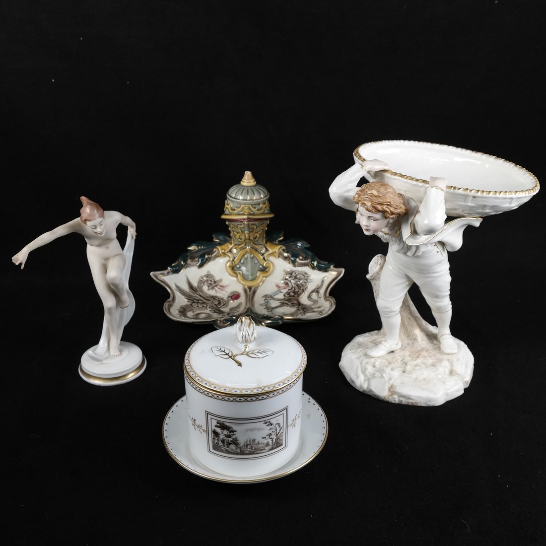 Group of Four Porcelain Decorative Items: Comprises: 1.) Inkwell with dragon motif. [5 1/2" H x 9" W]. Various chips. 2.) Figural candy dish featuring boy with basket on back, marked Royal Worcester. [8" H x 4" Dia]. Surface grime. 3.) Canist