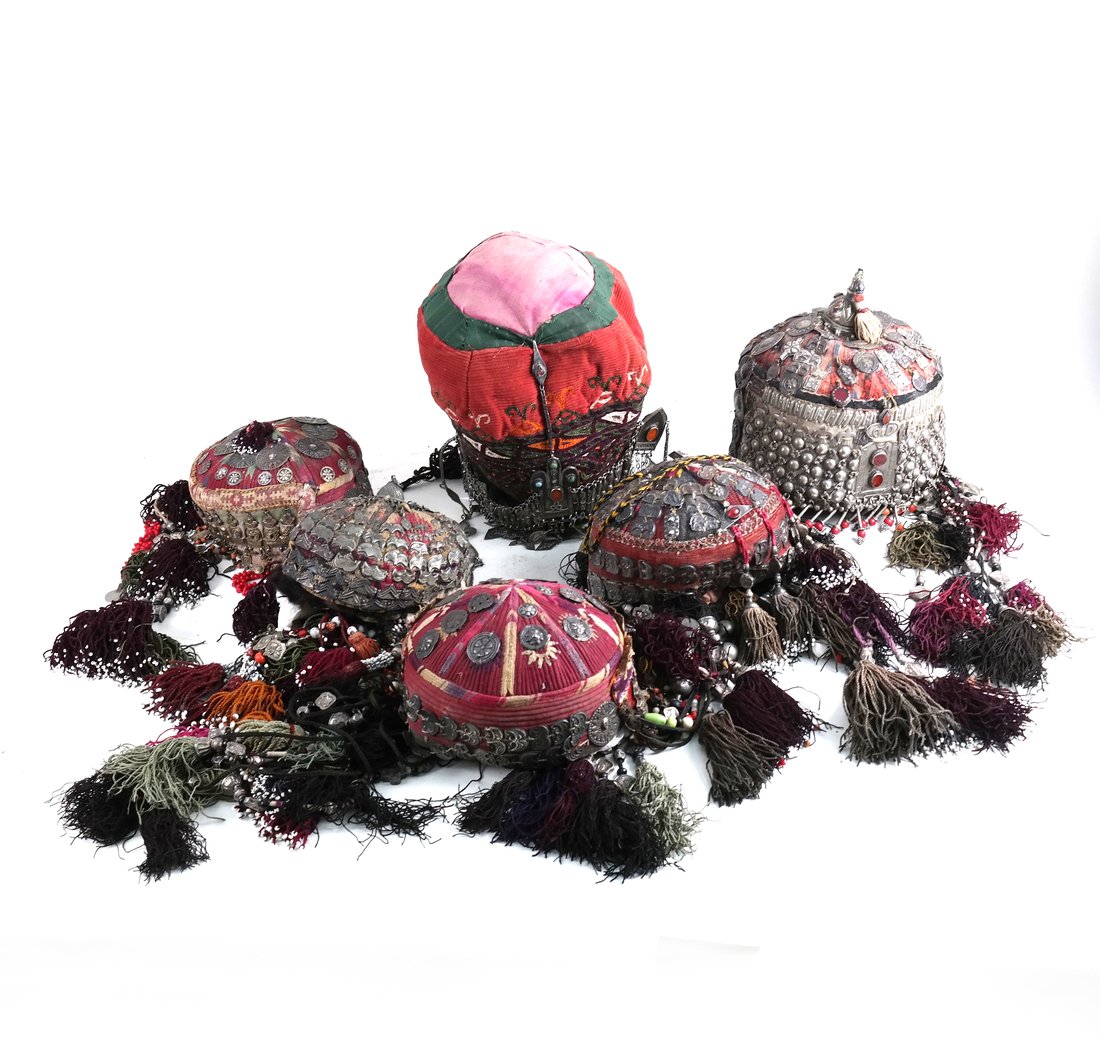Six Islamic Tribal Headdresses: Six Islamic tribal headdresses with beads, metal coins, tribal threads. [8" D x 11" H]. Worn but overall good condition.