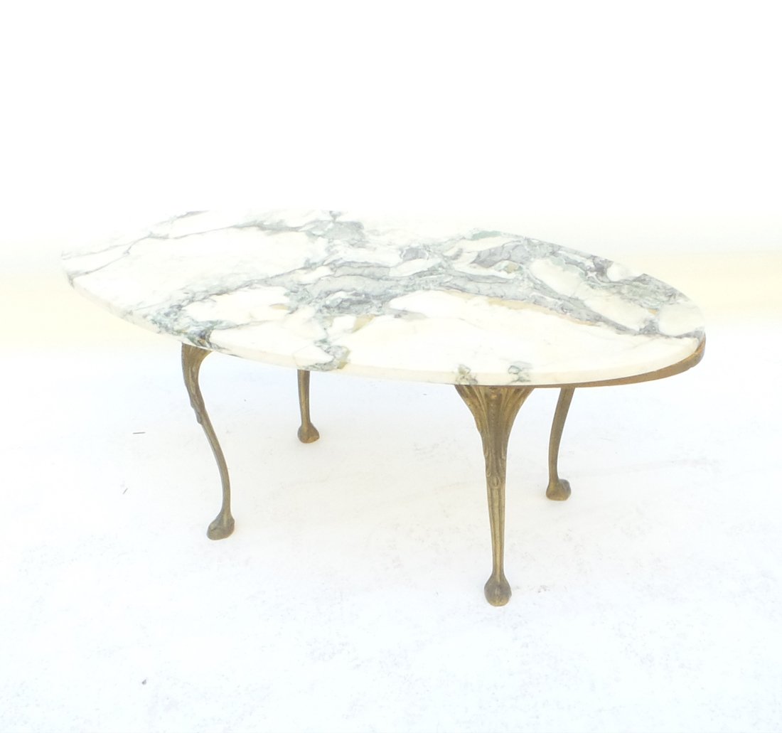 Marble Top Oval Table: Marble top oval table with bronze legs. [16" H x 20" x 40"]. In good condition.