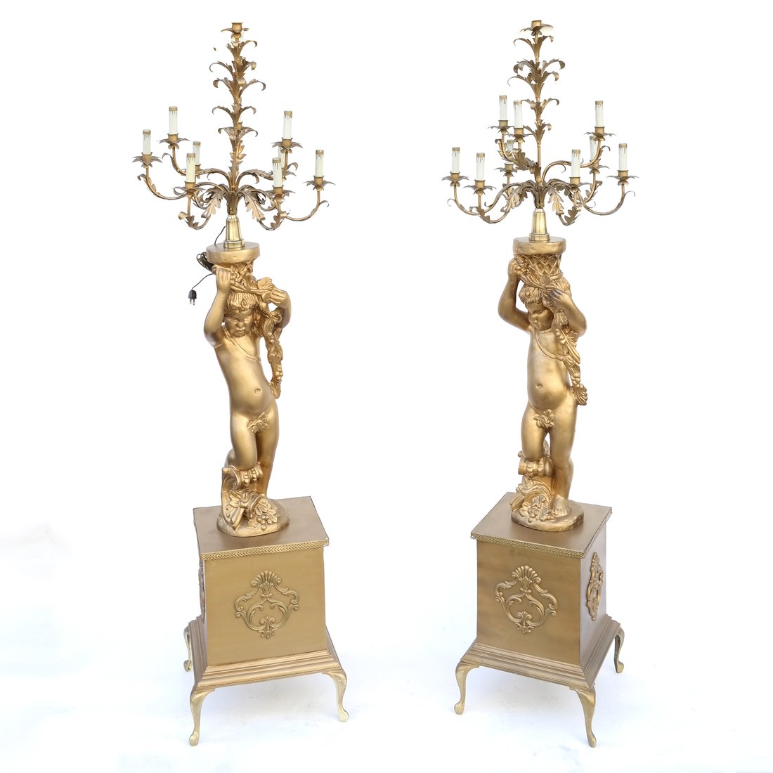 Pair of Life Size Candelabra: Pair of life size gilt painted wood putti candelabras, having eight lights, on square bronze mounted pedestals. [22" Dia x 57 1/2" H]. In good condition.