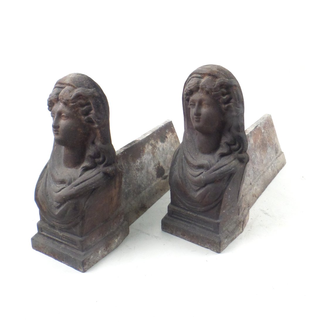 Pair of Small Iron Figurative Andirons: Pair of small iron figurative andirons depicting female busts. [8 1/4" H x 3 1/4" W x 10" L]. In good condition.