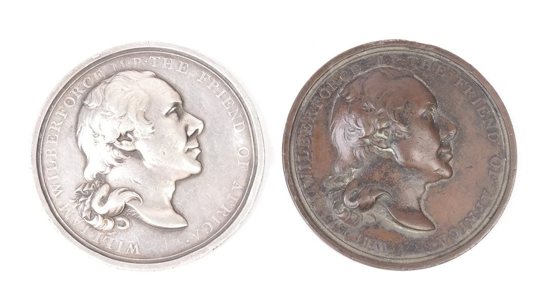Britain Slave Trade Abolished Pair: A pair of William Wilberforce 1807 Abolition of the Slave Trade medals by Thomas Webb. The silver medal on a thinner planchet and previously worn in a loop with rim marks. A bronze version of the meda