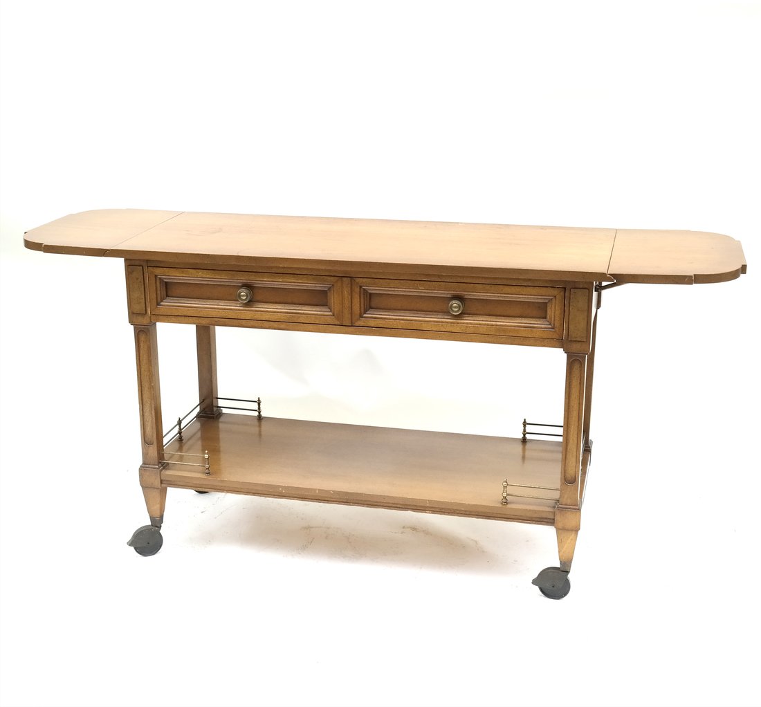 Modern Weiman Bar Cart: One-drawer bar cart with drop-leaf sides, lower shelf with brass gallery, and caster feet. [45" W x 18" D x 31 1/4" H]. Wear and loose drawer.