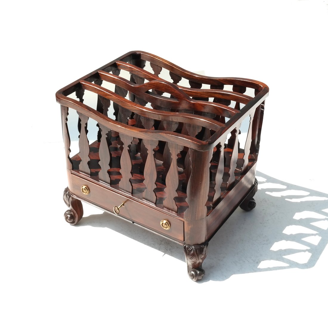Exotic Wood Canterbury: Exotic wood canterbury magazine rack with drawer and key on four scroll and leaf motif feet. [21 1/4" x 17 1/2" x 19 3/4" H]. In good condition.