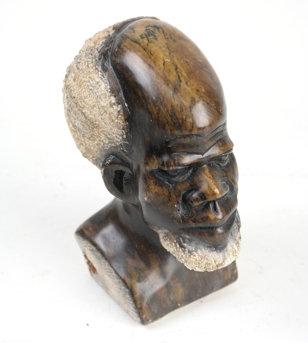 Soapstone Carving of an African Man: Soapstone carving of an African man. [7 1/2" H x 3 1/2" W x 5 1/2" D]. Scratches.