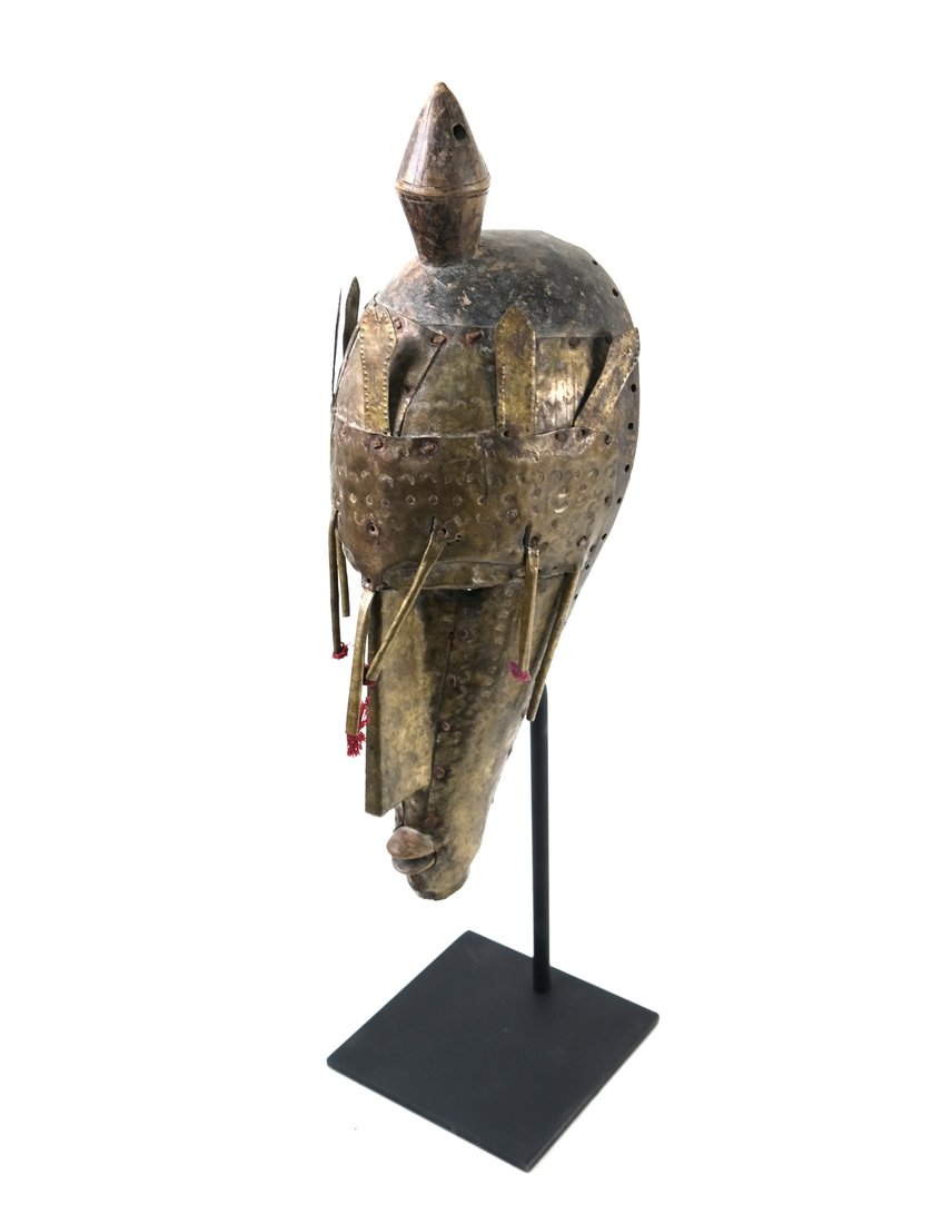 Metal and Wood Tribal Mask and Headdress: Metal and wood tribal mask/headdress mounted on metal stand. [20" H x 5" W x 5" D]. Some losses to wood and metal.