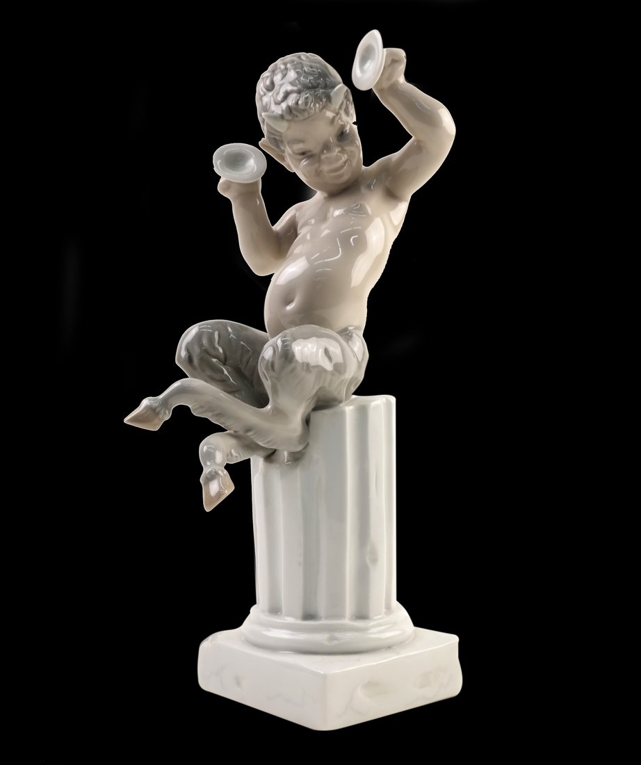 Lladro Figure of a Centaur: Lladro figure of a centaur seated on a pedestal holding bells. [11" H x 3 1/4" W x 3 1/4" D]