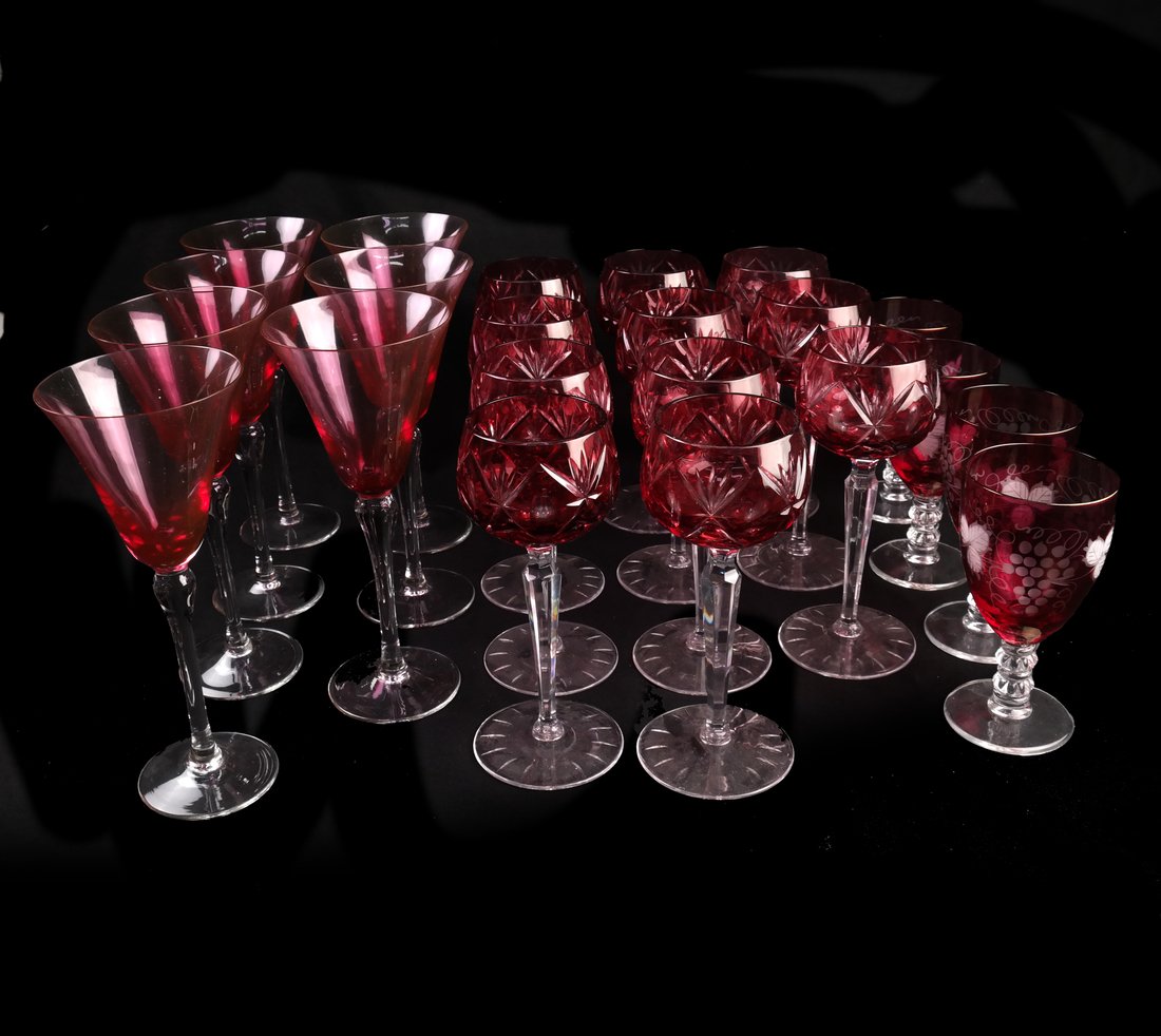 22 Ruby to Clear Glass Stemware: Lot of twenty-two ruby to clear assorted glass stemware. Three different styles, including, 1.) Cut glass goblets [7 1/2" H x 2 1/2" Dia] 2.) Etched glass with grapes [6" H] 3.) 7 martini glasses [9"