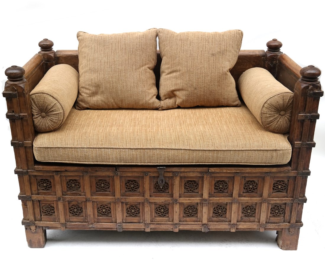 Hand Carved Balinese Daybed: Hand carved Balinese daybed with storage underneath the seat and a removable upholstered cushion. [38" H x 56" W x 29" D]. Scratches and marks.