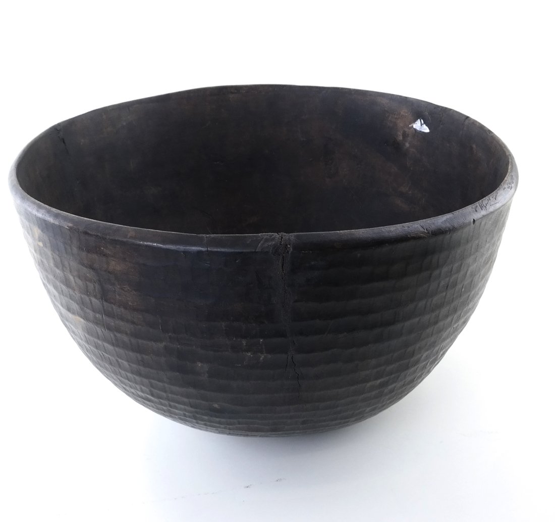 Antique Wooden Bowl: Deep antique wooden bowl. [19" Dia. x 11 1/2" H]. Cracks and repairs.