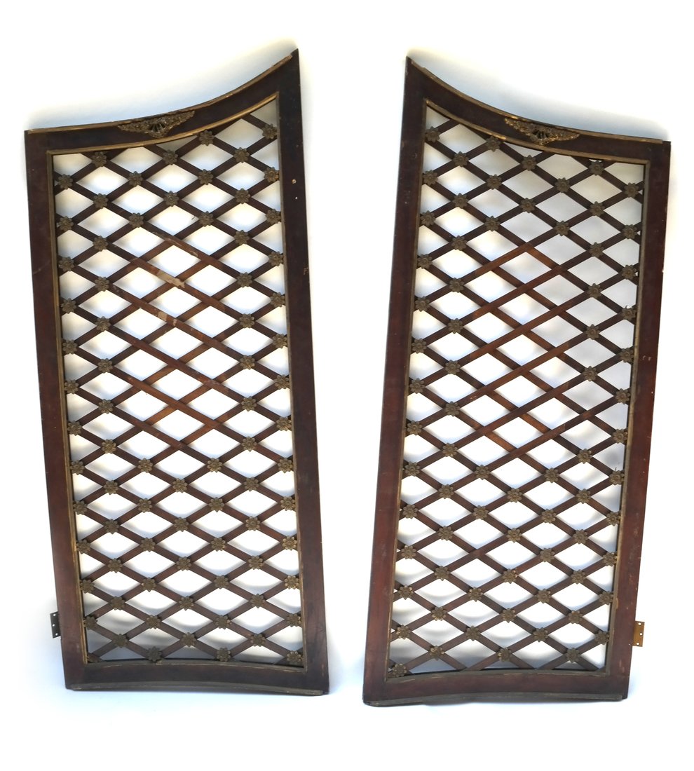 Pair of Antique Lattice Gates: Pair of antique lattice gates with diamond patterns and metal rosettes. [72" H x 62" W]. Rust and losses to wood.