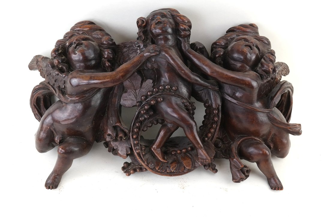 Italian Carved Cherub Wall Decoration: Italian carved wood cherub wall decoration. Modeled with three cherubs, 2 flanking a central smaller cupid figure. [12" H x 19" L x 4" D]. Losses to wood as well as surface scratches and marks. Has so