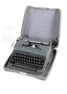 Olympia West German Typewriter: Typewriter with Cyrillic characters, accompanied by carrying case. Manufactured by Olympia, circa 1964. Serial number 1239418. Dimensions:15.00 " W x 10.00