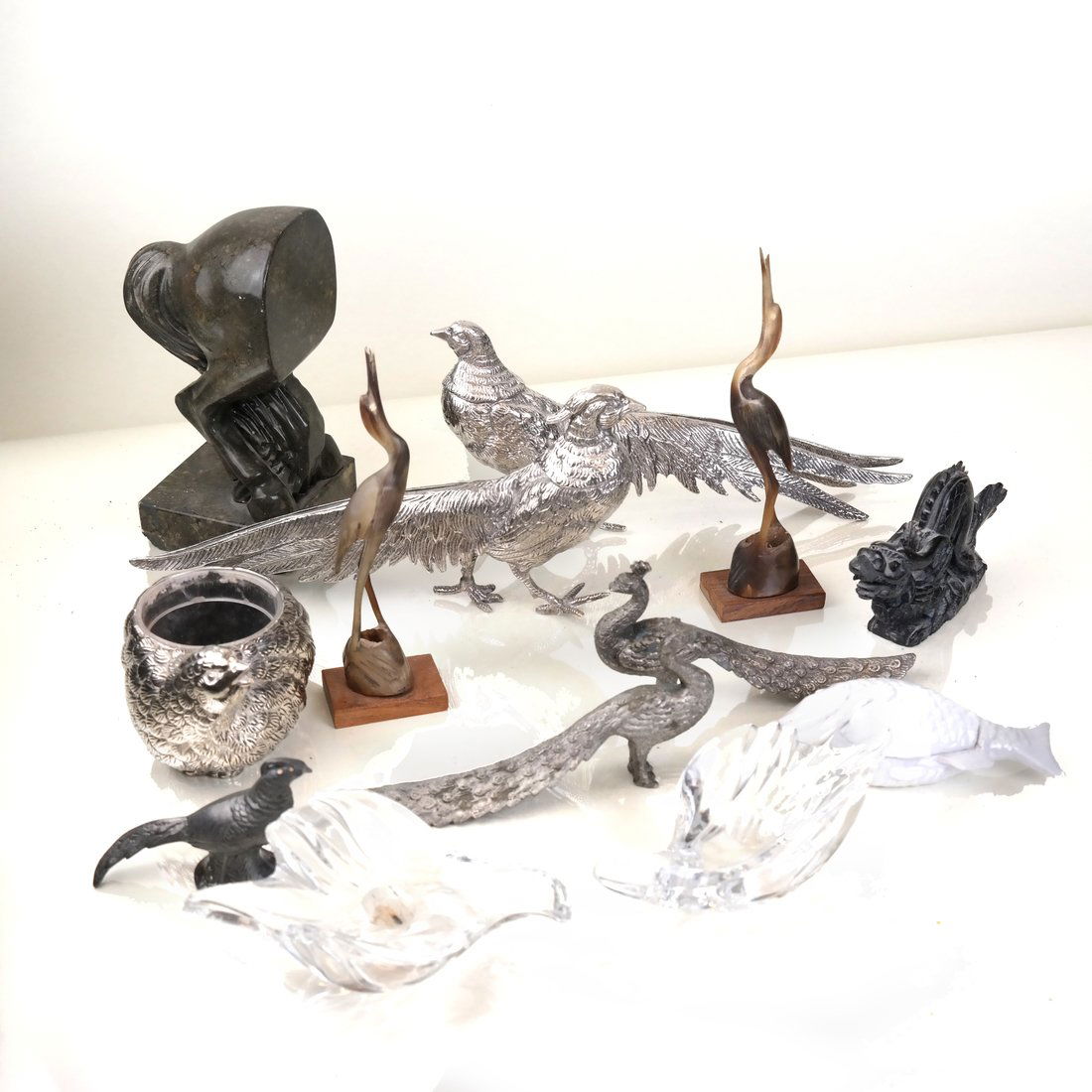 13 Miscellaneous Animal and Fish Figures: Late 20th Century, comprising glass, metal, stone and metal examples of pheasants, dragon, fish, quail, cranes or horses. [1 1/2" - 8" H x 2 1/4" - 11 1/2" L]. Wear overall; as is.