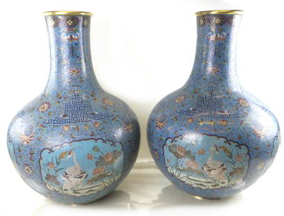 Pair of Decorated Enamel Vases: Pair of large cloisonne enamel vases with a blue ground and floral bird and leaf decor [24" H x 5 3/4" Dia (tops)]. Overall good condition.