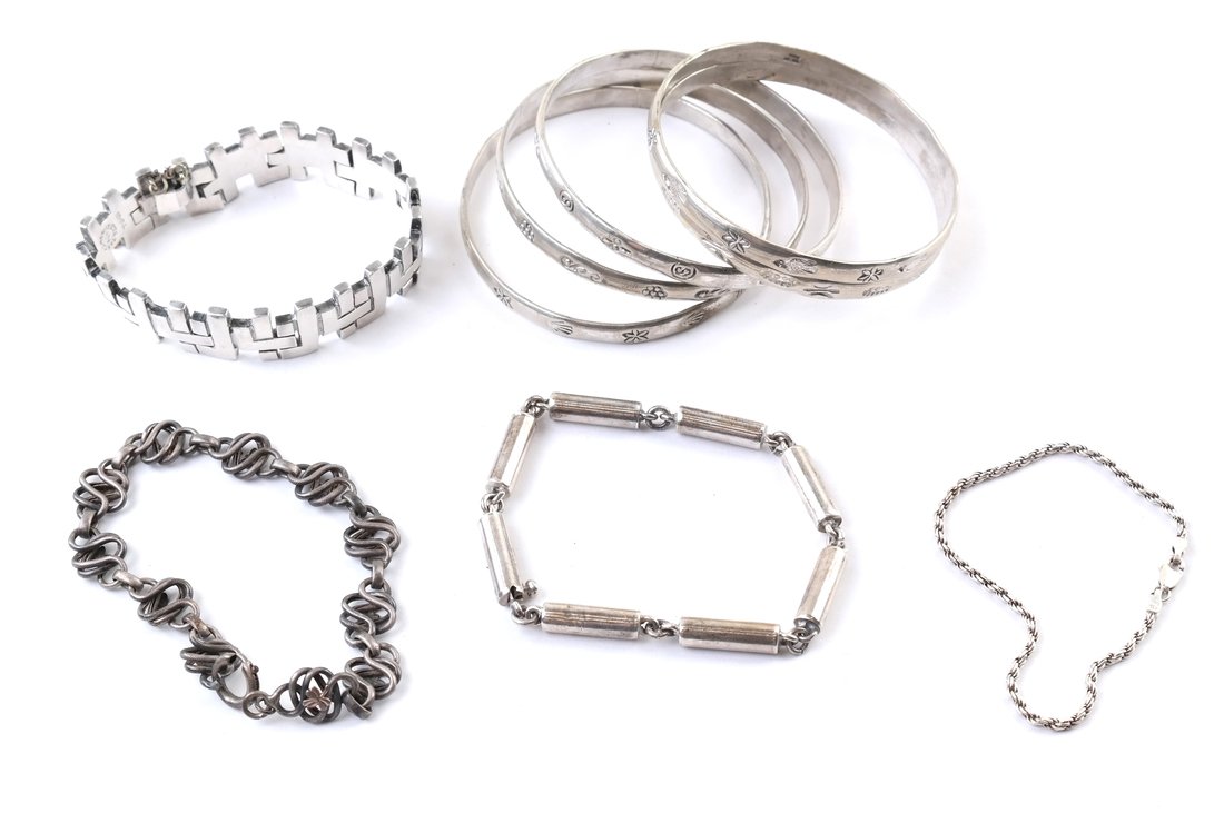 Nine Sterling Silver Various Bracelets: All struck sterling; mid-to-late 20th century, comprised of: three various link bracelets, a rope bracelet and a set of five bangle bracelets. [Total weight approximately 5 oz. troy].