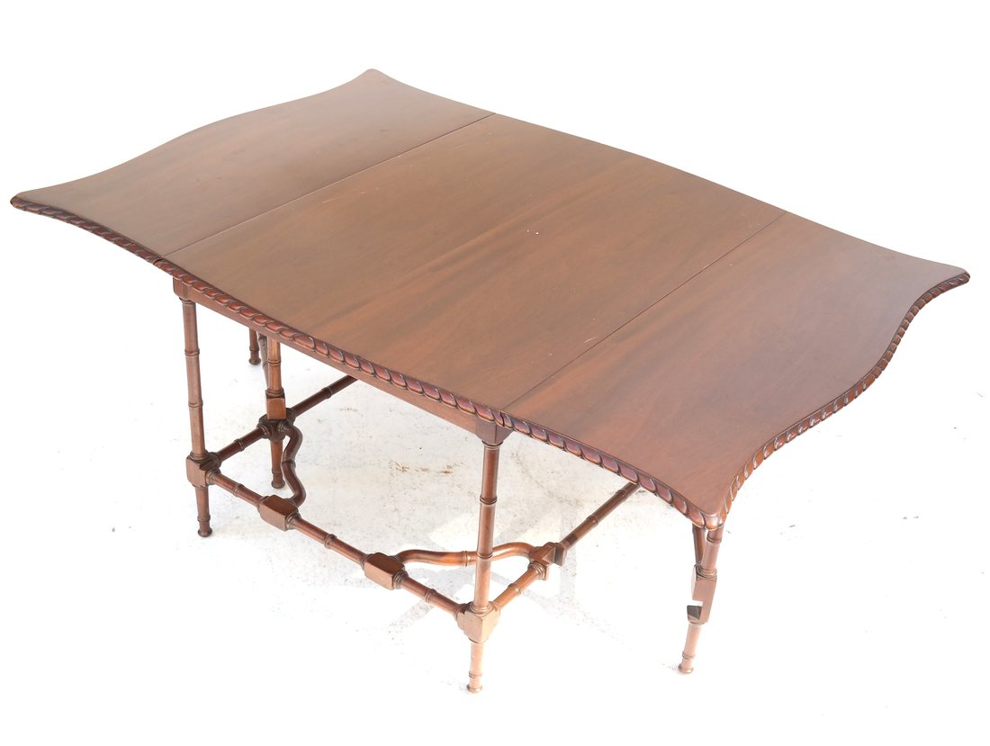 Mahogany Drop Leaf Cocktail Table: 20th century, American, mahogany drop leaf cocktail table, having faux bamboo spider legs. [17" H x 42" W x 29" D]. Scratches and marks.