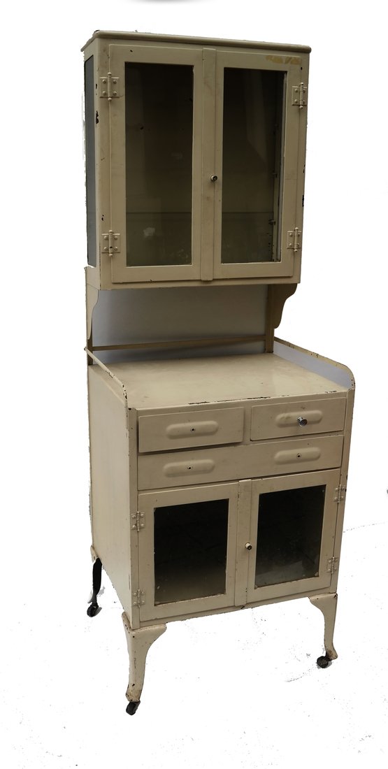 Industrial Beige Dental Cabinet: Industrial beige metal dental cabinet. [65" H x 23" x 19"]. Losses and abrasions, missing caster. Top doors and drawer locked, no key.