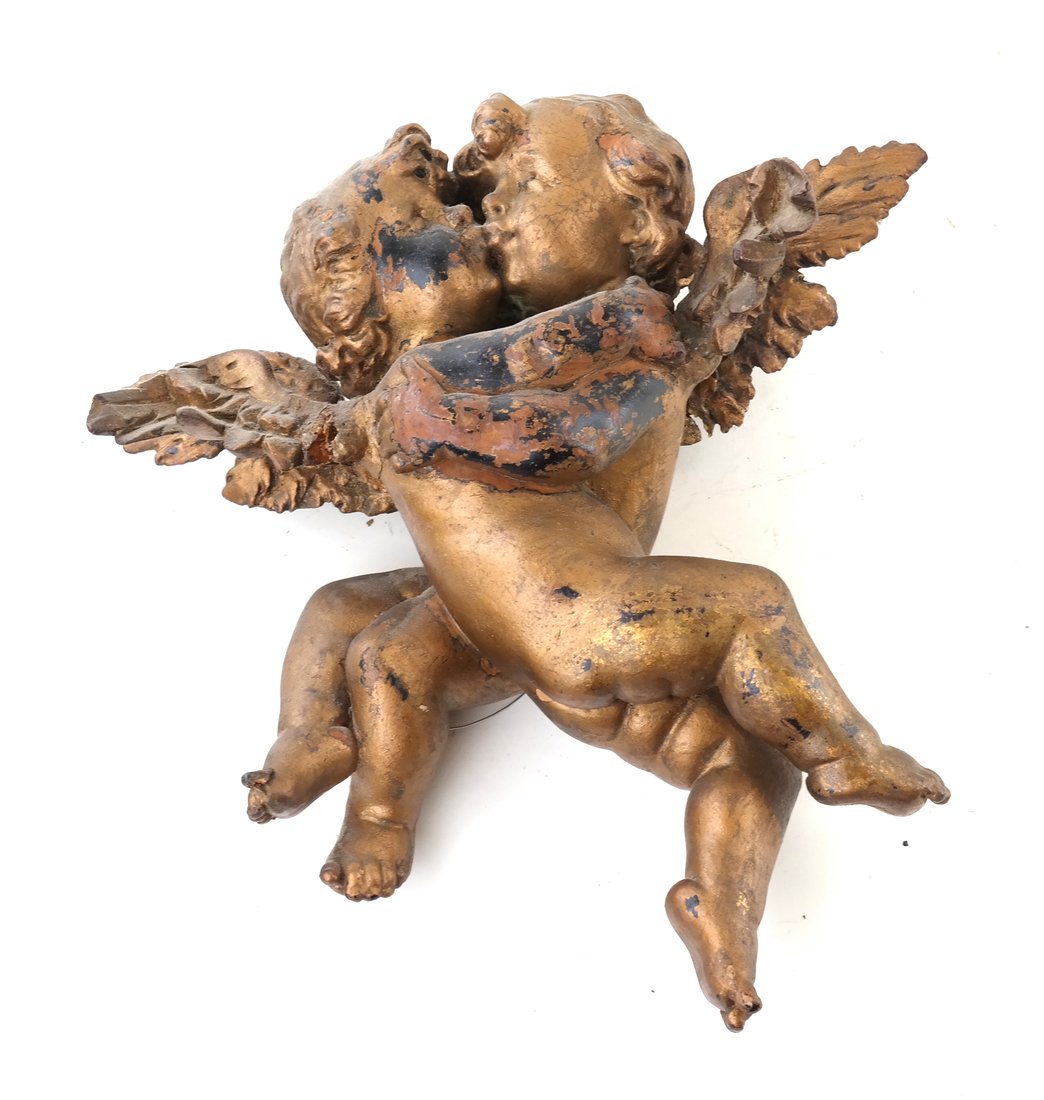 Antique Carved Gilt Cupid Decoration: Antique carved gilt composite decoration modeled as two cupids embracing. [15" H x 14" W x 6" D]. Both wings are loose.