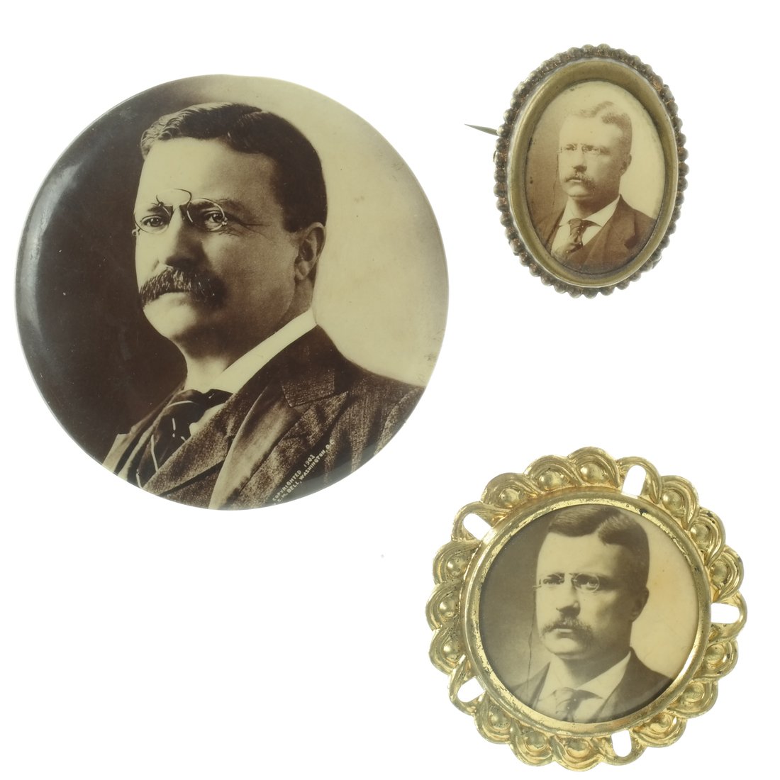 T. Roosevelt - Three Sepia Celluloids: Three sepia tone photographic printed celluloid portraits of Theodore Roosevelt, all wearing iconic pince nez glasses. Comprises: 1.) 2-1/4" later portrait with reverse mirror, imprinted on obverse, "