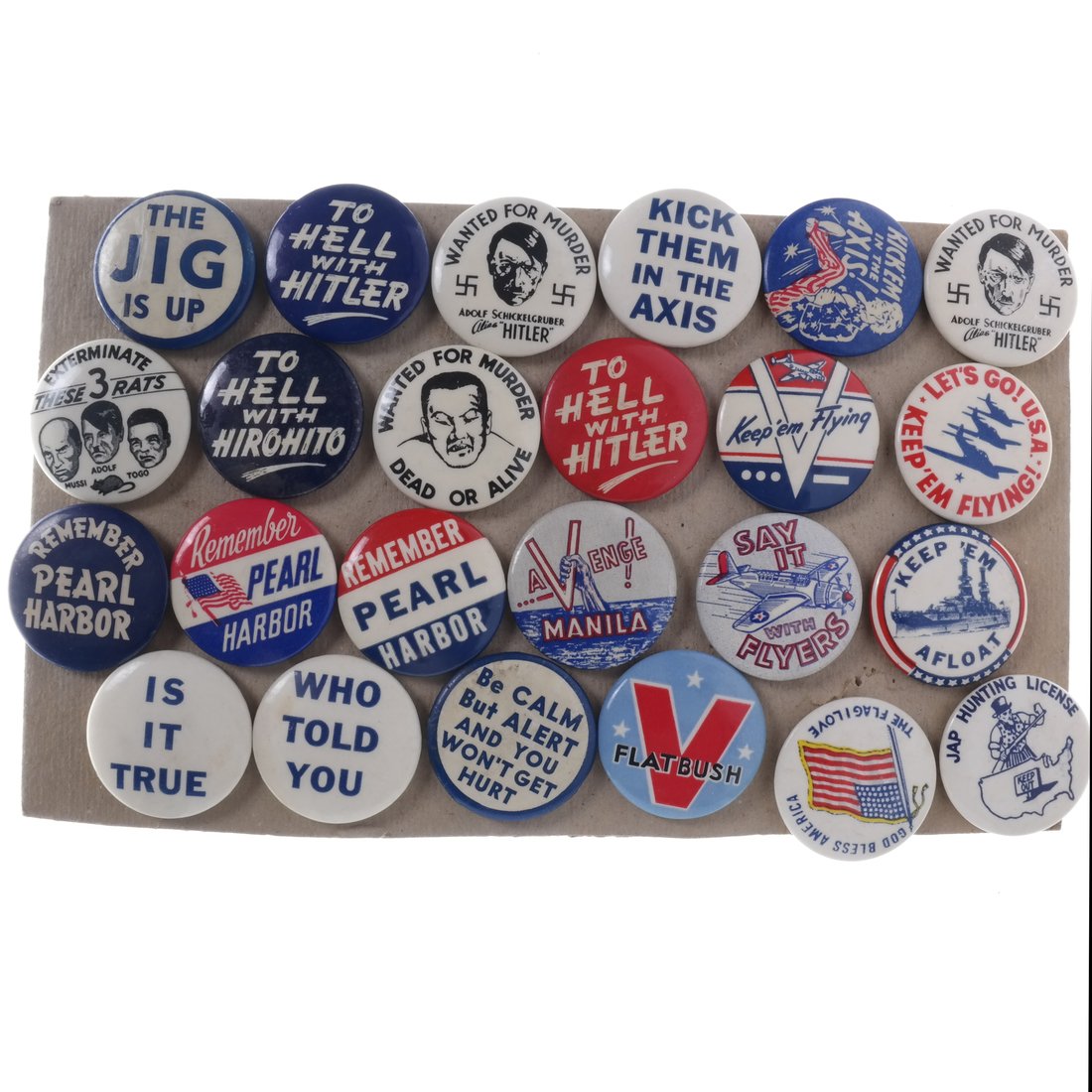 World War II - Twenty-Four Assorted Celluloid Buttons: All 1-1/4" celluloid pinbacks. Including examples inscribed "To Hell with Hitler", "Is it True", "Kick Them in the Axis", "Keep 'Em Afloat".