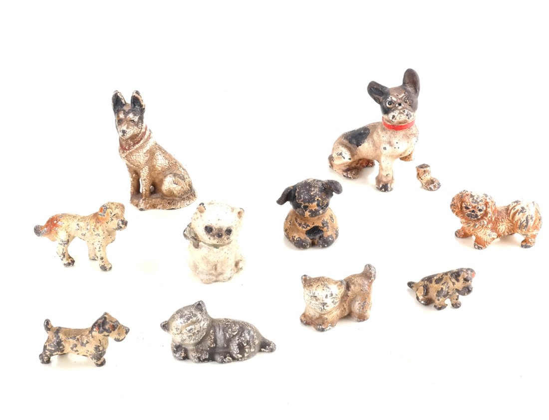 Ten Painted Cast Iron Animal Party Favors: All variously modeled and painted, including: three cats and seven dogs. [Height: 1" to 3 1/4"; Width: 1 1/2" to 2 1/2"].