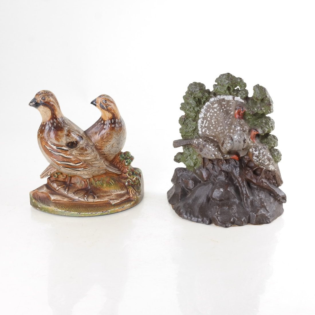 Two Painted Cast Iron Bird Doorstops: The first modeled and painted as three turkeys, possibly by Hubley Mfg. Co., the reverse impressed "139". [6 1/4" H x 5 3/4" W]. The second modeled and painted as two quail, probably designed by Fred 