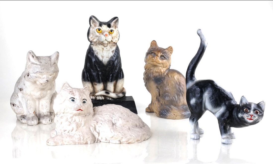 Five Painted Cast Iron Cat Doorstops: Comprising: four various full-bodied, hollow-cast cats, including: Sleeping Cat by Hubley Mfg. Co., and Persian Cat by Hubley Mfg. Co., two other cats, and a doorstop modeled in relief as a cat seated