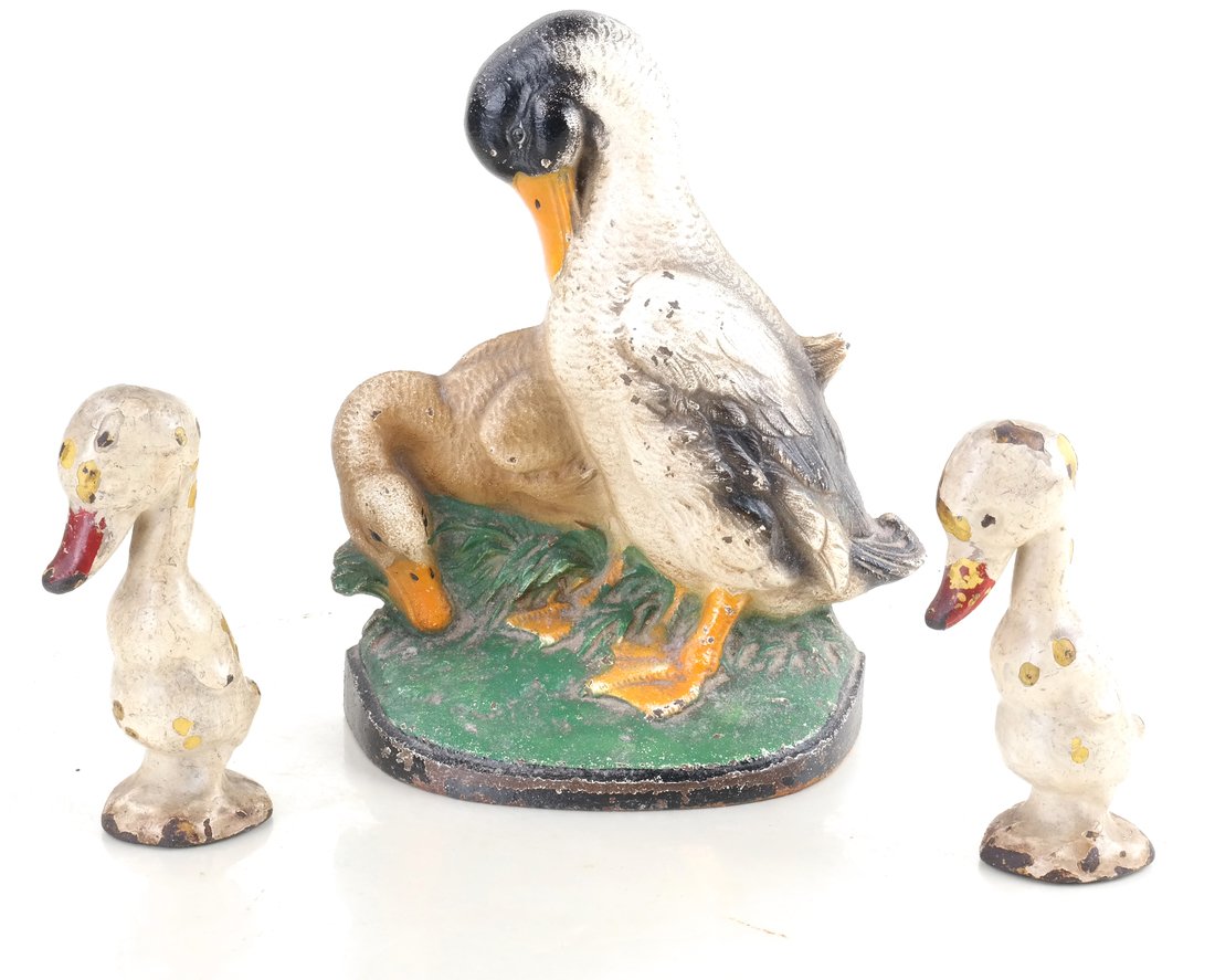 Three Painted Cast Iron Duck Figures: Including a doorstop modeled as a drake and hen, the reverse impressed "291", and two full-bodied, solid-cast small figures of ducklings. [Height: 4 3/4" and 8 1/4"; Width: 2 1/2" and 7"].
