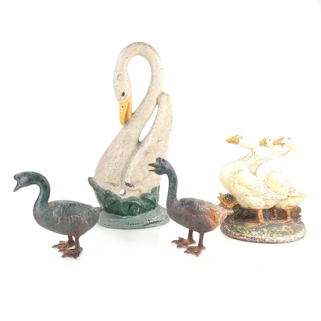 Four Painted Cast Iron Birds: Comprising: Geese doorstop designed by Fred Everett, by Hubley Mfg. Co., modeled as painted as three white geese, the front impressed "Fred Everett" and with copyright symbol, the reverse impressed "4