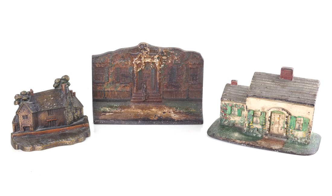 Three Cast Iron Architectural Doorstops: Comprising: a relief modeled doorstop modeled as a lady at a Federal style doorway, the reverse inscribed in relief "Eastern Specialty Mfg. Co. / No. 50"; a painted cottage, and a painted relief of a 