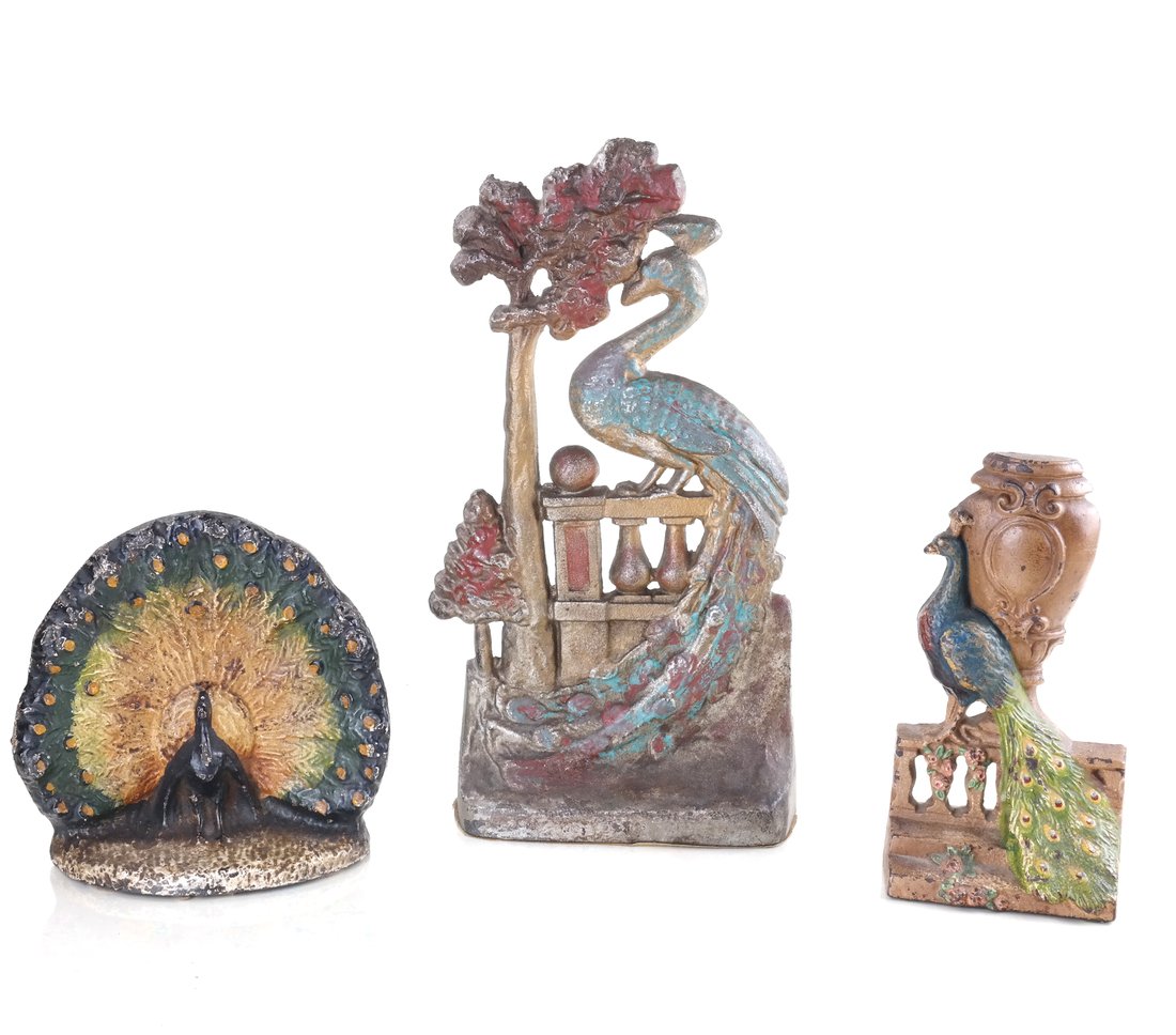 Three Painted Cast Iron Peacock Figures: Comprising: Peacock on Fence doorstop by National Foundry, the reverse impressed "56", a Peacock by Urn doorstop by Hubley Mfg. Co., the reverse impressed "208", and a doorstop modeled as a Peacock di