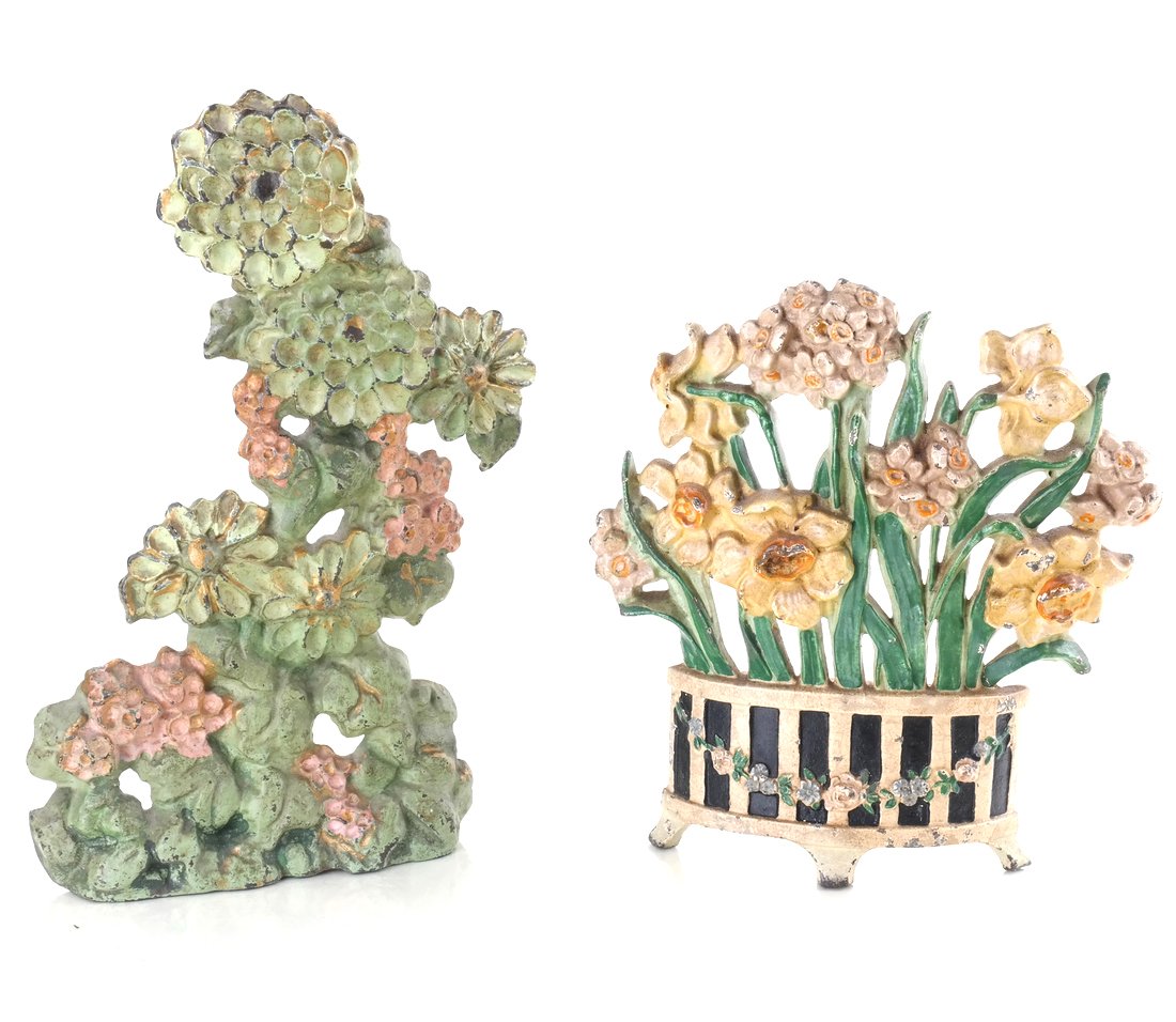 Two Cast Iron Floral Doorstops: Each painted in colors; comprising: "Narcissus" (#266) by Hubley Mfg. Co., [7 1/4" H x 7" W] and "Floral" group, reverse impressed with angular monogram "LVL / PAT. Appl. for" [9 1/4" H x 6 3/4" W].