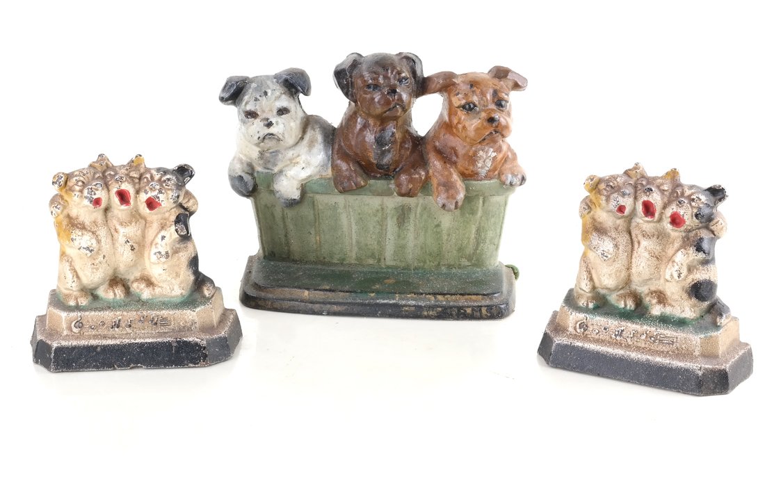 Three Cast Iron Pup Groups: Comprising: a doorstop modeled in relief and painted as Puppies in a Basket by Wilton Products, and two bookends modeled in relief and painted and three singing or howling puppies, [Sizes from 6 3/4" 