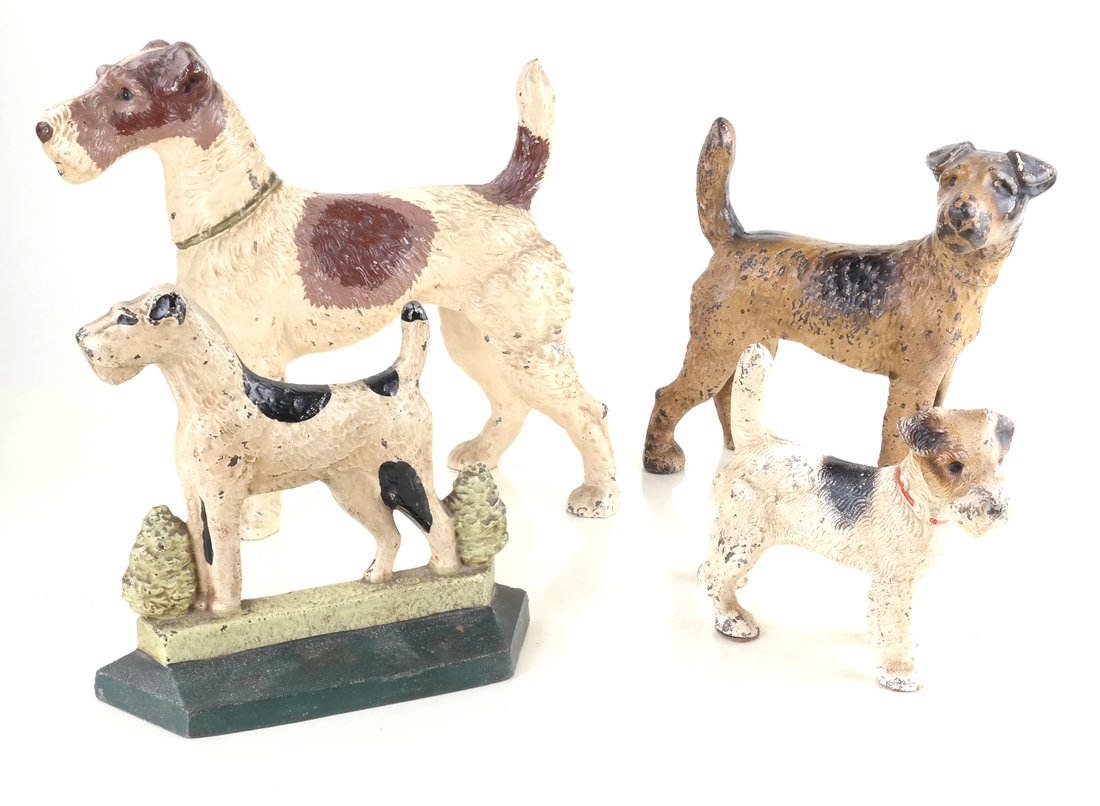 Four Painted Cast Iron Terriers: Comprising: a large hollow-cast, full-bodied Terrier by Hubley Mfg. Co., apparently unmarked, a hollow-cast, full-bodied Large Wire Haired Terrier by Hubley Mfg. Co., or National Foundry, a solid-cast
