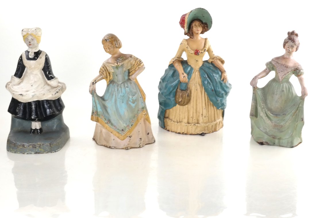 Four Painted Cast Iron Lady Doorstops: Each modeled in relief, comprising: "Maid" holding her apron in each hand (reverse impressed "1242"), "Minuet Girl" holding a pinafore in her right hand (reverse impressed "1278"), "Woman With Curtsey