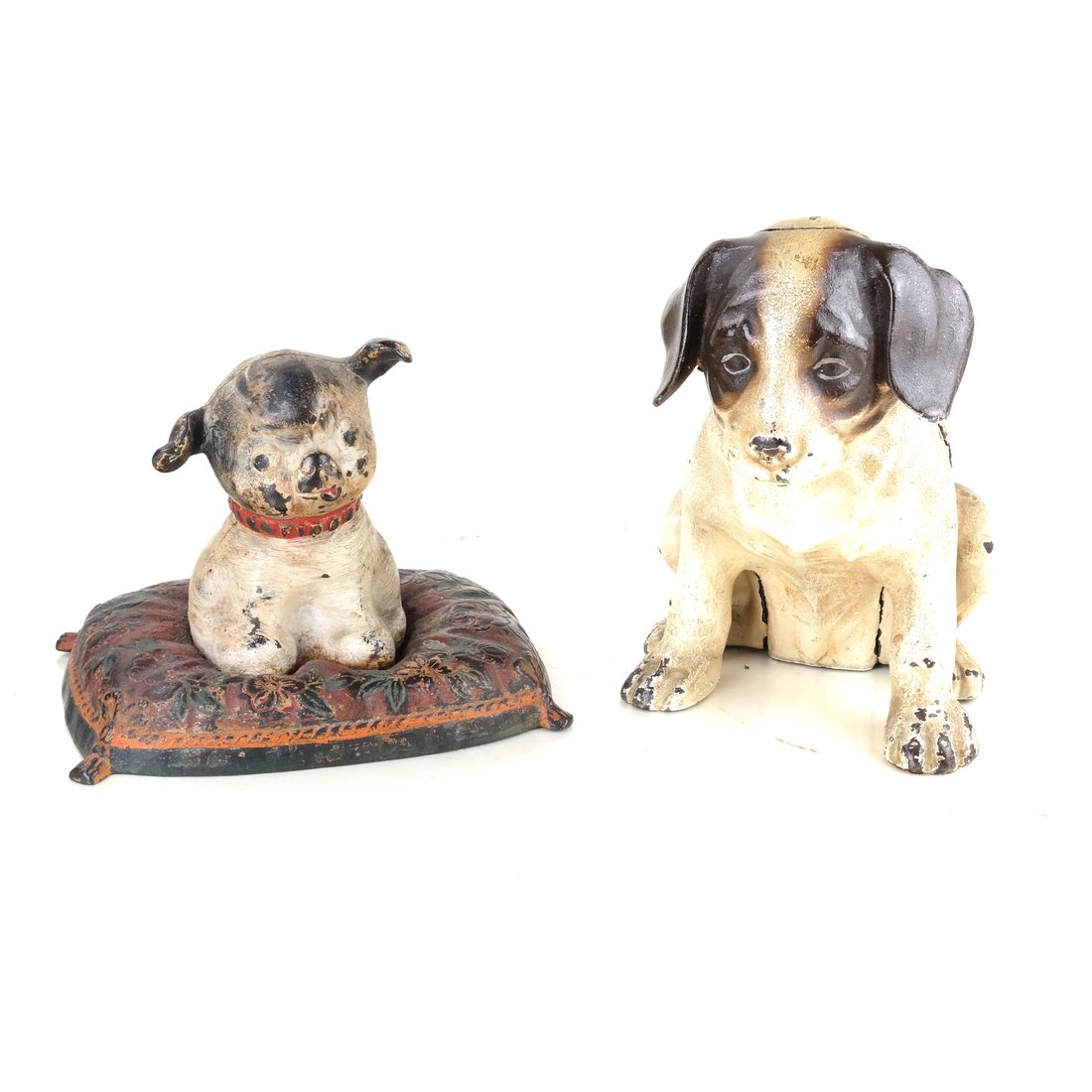 Two Painted Cast Iron Pups: Including a doorstop modeled as a hollow-cast, full bodied figure of a Beagle pup, and a hollow-cast, full-bodied figure of Fido on a Pillow by Hubley Mfg. Co., the reverse of his head impressed "DSGN